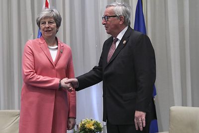 British Prime Minister Theresa May shakes hands with European Commission President Jean-Claude Juncker on Monday.