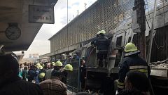 Image: Rescue workers attend a fire at the main train station in Cairo