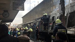 Image: Rescue workers attend a fire at the main train station in Cairo