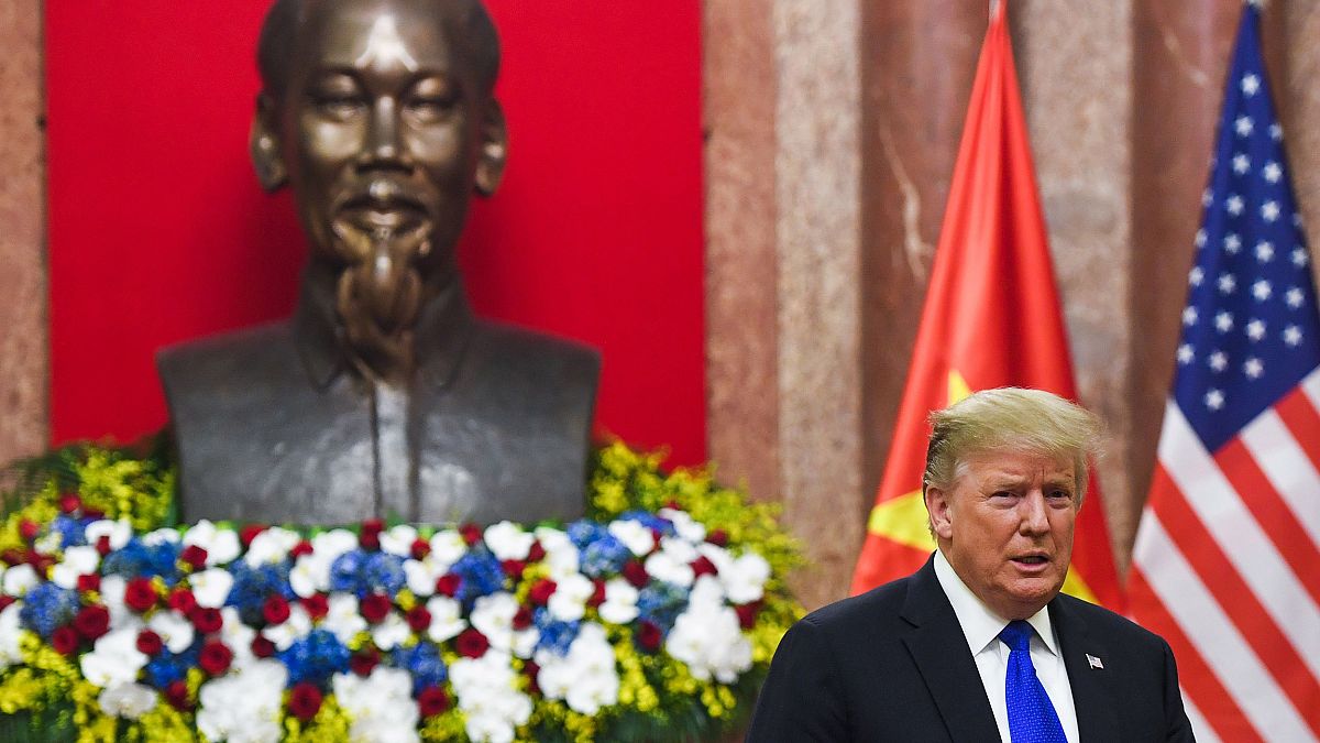 Image: President Donald Trump stands next to a bust of late president Ho Ch