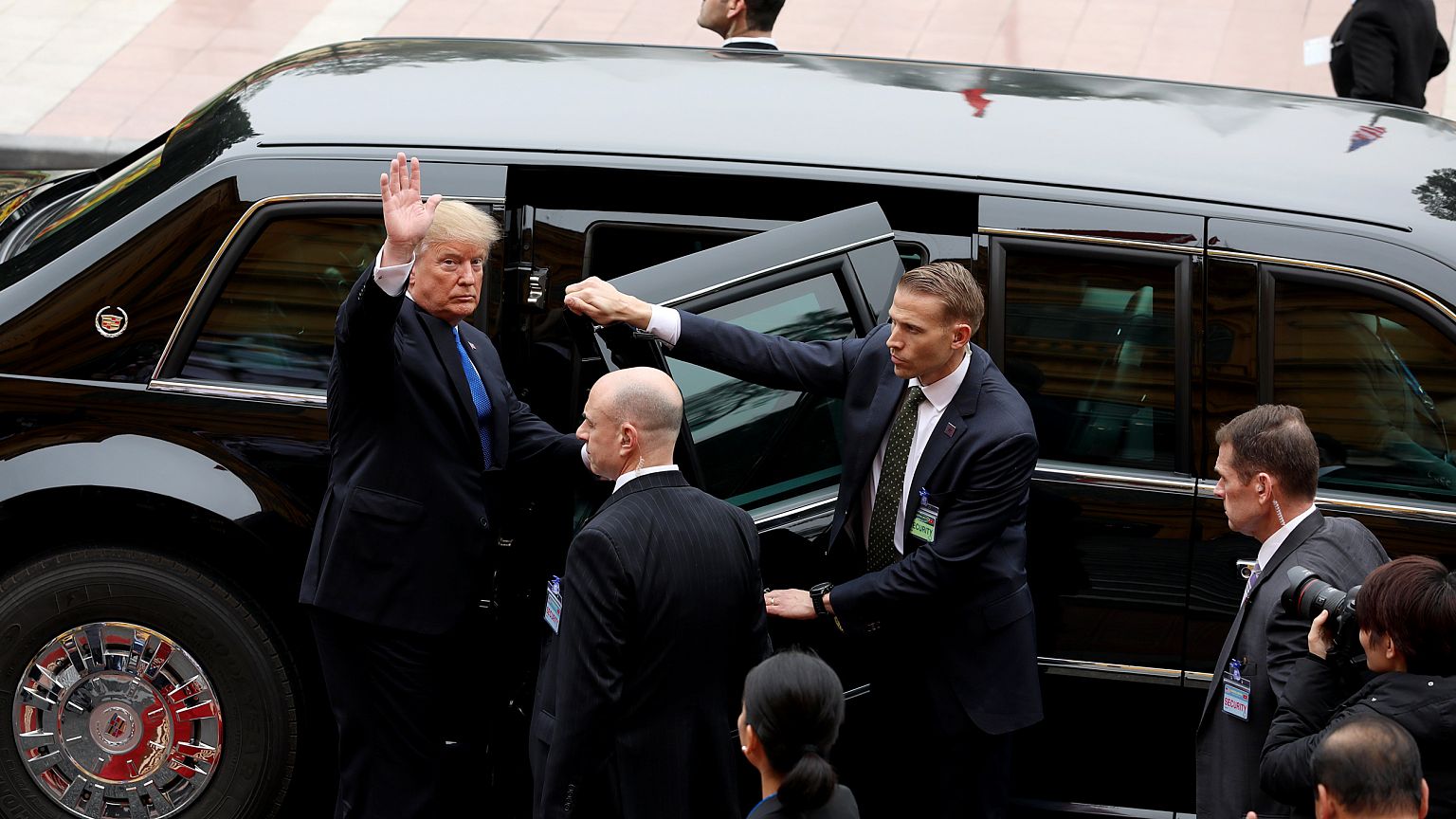 Image: President Donald Trump waves after a meeting in Hanoi, Vietnam, on F