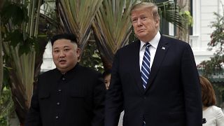 Image: President Donald Trump and North Korean leader Kim Jong Un take a wa