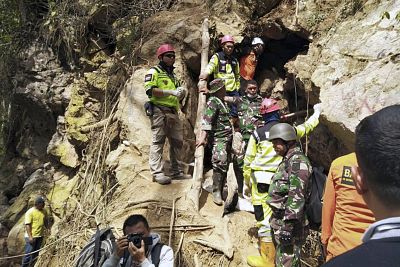 Rescuers stand at the entrance of a collapsed mine in Bolaang Mongondow, North Sulawesi, Indonesia on Feb. 28, 2019.