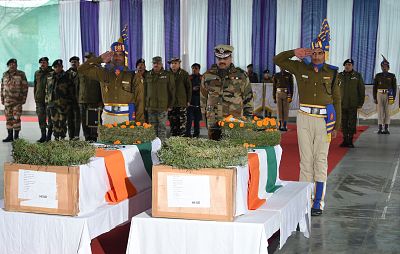 Indian paramilitary officers salute during the wreath laying ceremony of two slain paramilitary troopers at the Central Reserve Police Force headquarters in Srinagar on March 2, 2019.