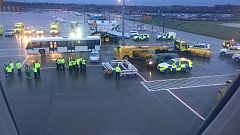 Image: Emergency personnel wait for passengers to disembark a flight from B