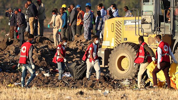 Image: Members of the search and rescue mission carry dead bodies at the sc Image: Members of the search and rescue mission carry dead bodies at the sc