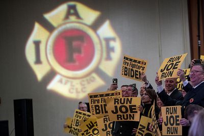 Firefighters in the audience cheer as former Vice President Joe Biden takes the stage to speak to the International Association of Firefighters at the Hyatt Regency in Washington on March 12, 2019.