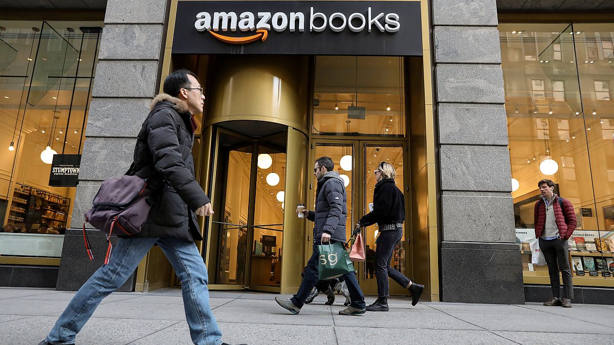 Image: People walk past an Amazon Books retail store in New York