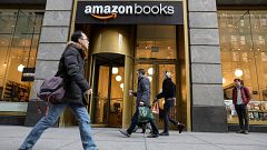 Image: People walk past an Amazon Books retail store in New York