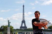 French Open champion Rafael Nadal relaxes with his trophy, the 10th Roland garros title of his career