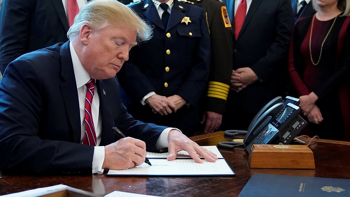 Image: President Donald Trump signs veto of congressional resolution to end
