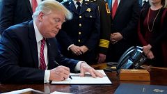 Image: President Donald Trump signs veto of congressional resolution to end