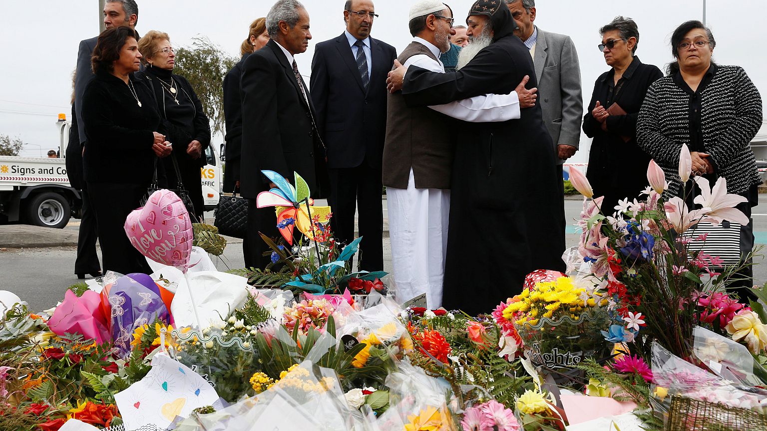 Image: Imam Ibrahim Abdul Halim of the Linwood Mosque is embraced by Father