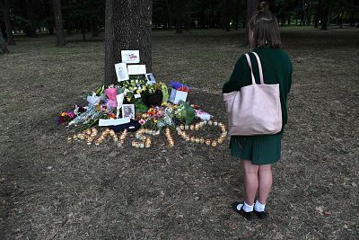 A student pays respect at a memorial site for the victims of mosque attacks in Christchurch on Tuesday.