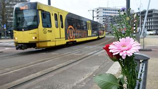 Image: Flowers have been set up in tribute to victims at the site of a shoo