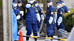 Image: Police investigate the scene after a woman was stabbed by her husban