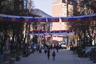 Kosovan Serbs walk under Russian and Serbian flags at the main square in the north of Mitrovica.