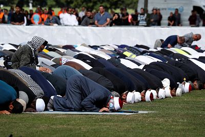 People perform the Friday prayers at Hagley Park outside Al-Noor mosque in Christchurch, New Zealand on March 22, 2019.