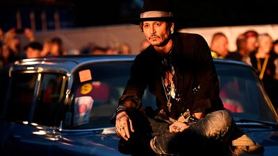 Johnny Depp makes an entrance at Glastonbury