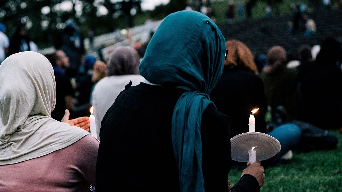 Image: People attend a vigil for the lives taken in the Christchurch terror