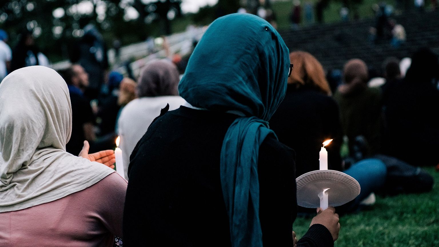Image: People attend a vigil for the lives taken in the Christchurch terror