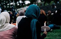 Image: People attend a vigil for the lives taken in the Christchurch terror