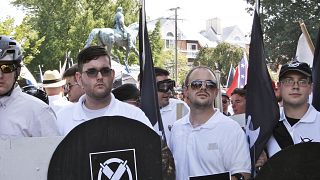 Image: James Alex Fields Jr., second from left, holds a black shield during
