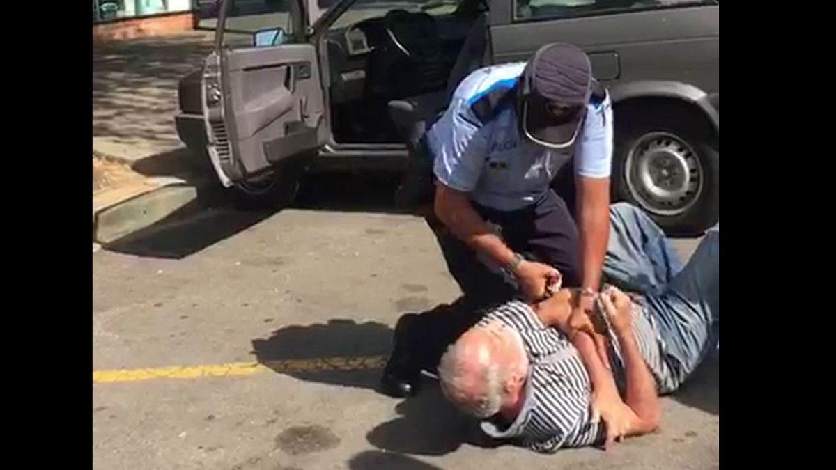 Watch: Police wrestle pensioner to ground in parking dispute