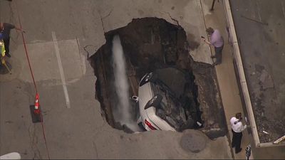 Parked car swallowed up by sinkhole