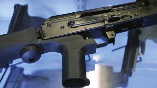 Image: A bump stock is attached to a semi-automatic rifle at store and gun 