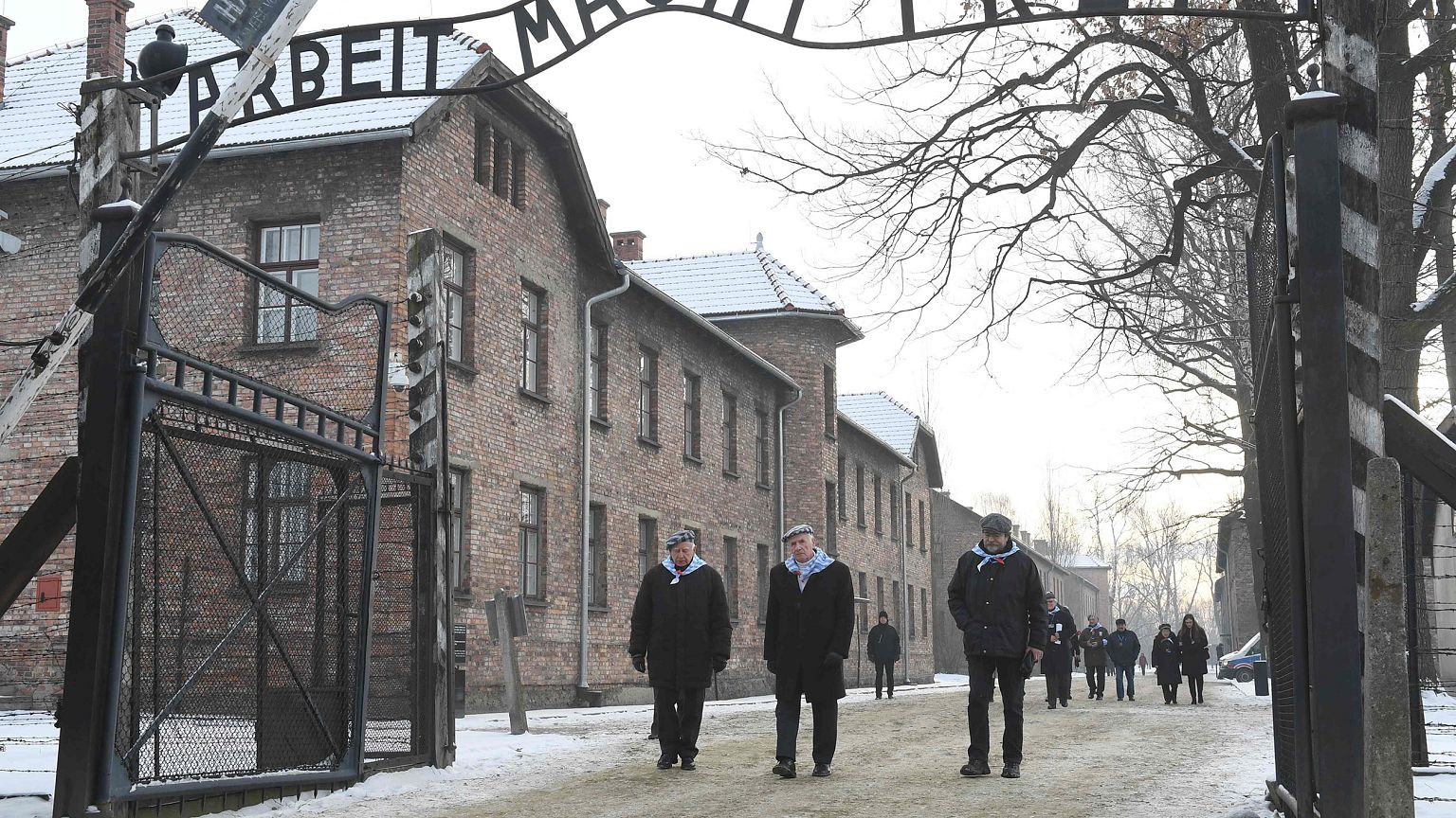 Image: People pass the main gate after the 74th anniversary of the liberati