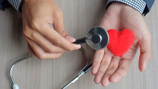 Cropped Hands Of Doctor With Heart Shape Toy