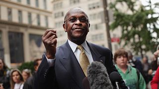 Image: Herman Cain speaks to the media outside Trump Tower before a meeting