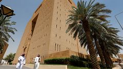 Image: Saudi men walk outside the General Court in Riyadh
