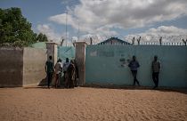 Image: Refugees crowd around a UNHCR field office in the Dadaab refugee cam