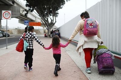 A migrant mother walks with her two daughters on their way to the port of entry to ask for asylum in the U.S. last June in Tijuana, Mexico.