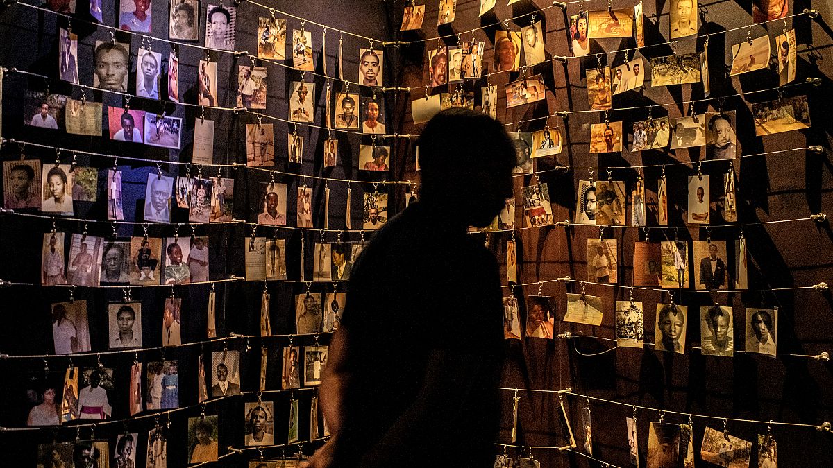 Image: Photos of people who were killed in the 1994 Rwandan genocide hang i