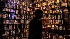Image: Photos of people who were killed in the 1994 Rwandan genocide hang i