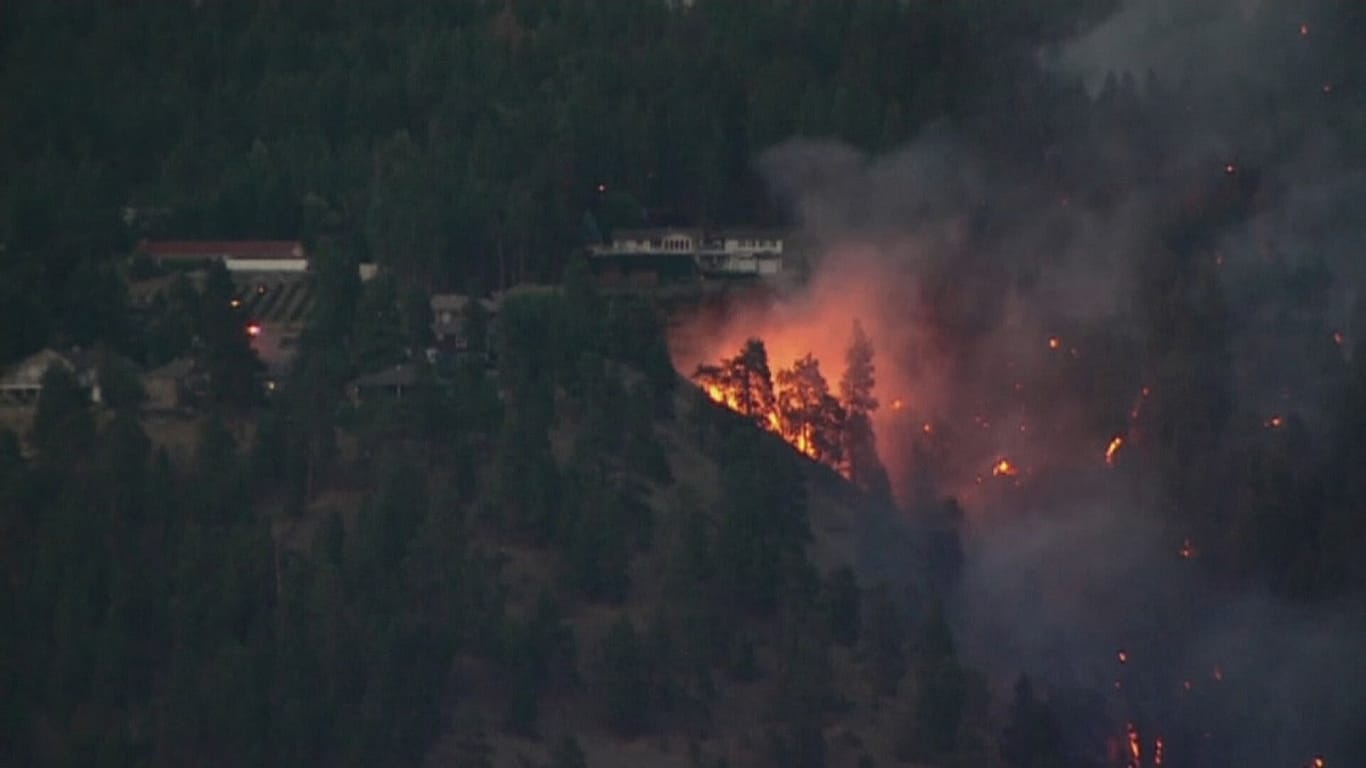Tens of thousands of people evacuated as wildfires continue to sweep ...