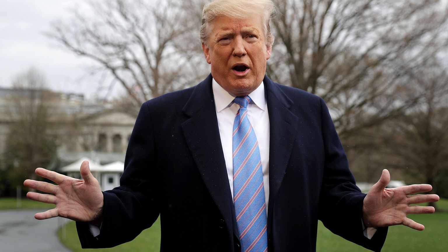 Image: President Donald Trump speaks to the media as he departs the White H