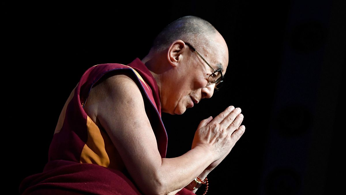 Image: The Dalai Lama gestures during a group hearing in Paris on Sept. 13,