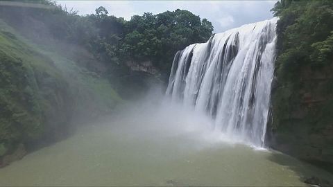 Tourists flock to China's waterfalls to escape the heat