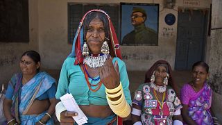 Image: An Indian Lambada tribal woman shows the indelible ink mark on her i