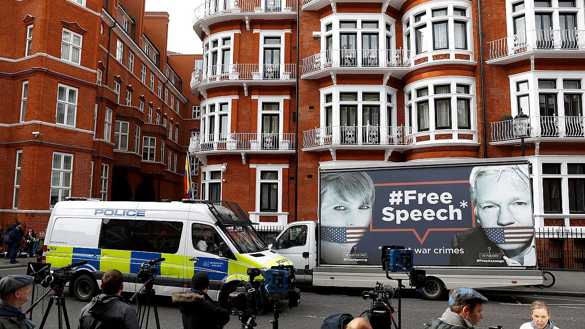 Image: A police van and truck outside the Ecuadorian Embassy in London