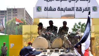Image: Sudanese military sit on their armoured personnel carrier near the D