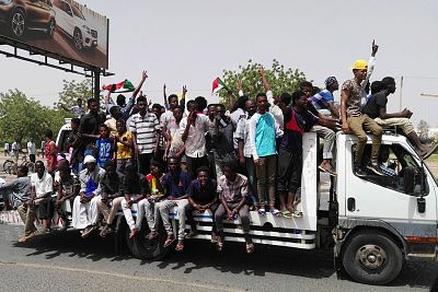 Sudanese men celebrate while rallying in the capital Khartoum on April 11.