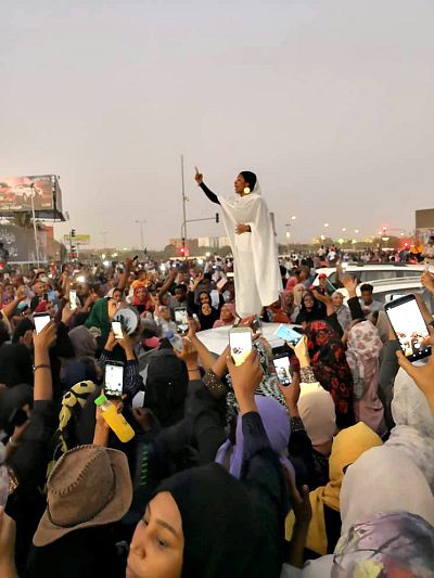 Alaa Salah gestures during a protest demanding Sudanese President Omar Al-Bashir to step down along a bridge in Khartoum, Sudan April 8.
