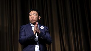 Image: Democratic presidential candidate Andrew Yang exits the stage after 