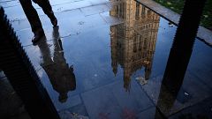 Image: The Houses of Parliament is reflected in an puddle in London, Englan