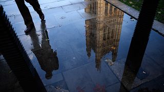 Image: The Houses of Parliament is reflected in an puddle in London, Englan